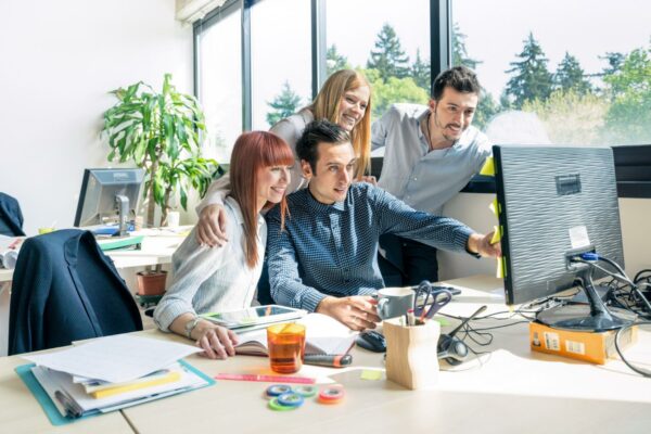 team employee workers with computer open space home